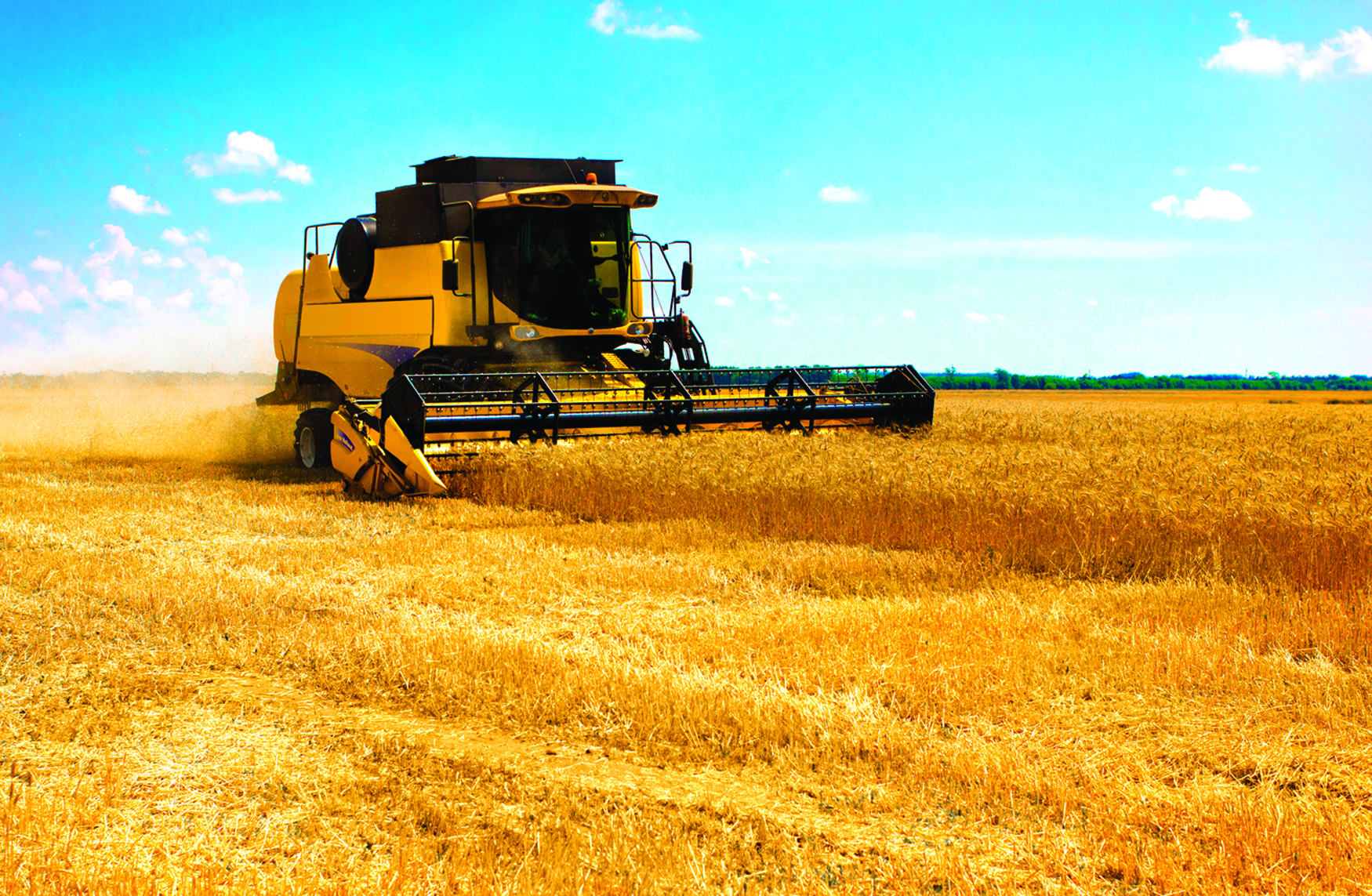 An image of a combine harvester working in a field.